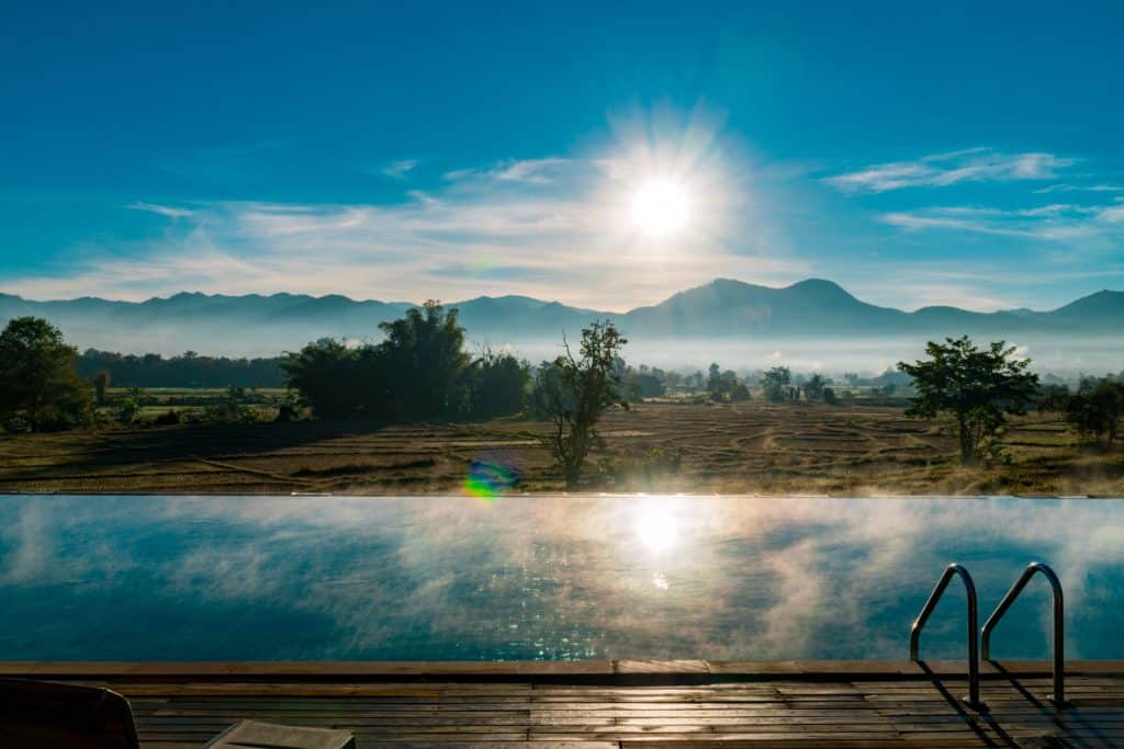 Sun rise over the mountains and a swimming pool in Pai