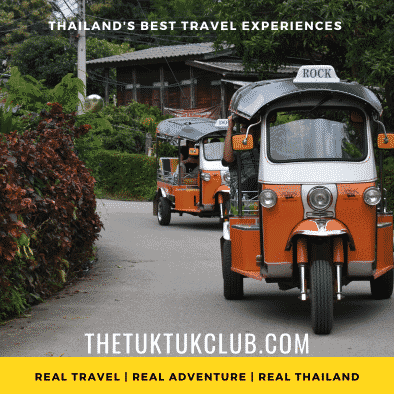 Two Tuk Tuks driving through a small country lane in a Northern Thailand village